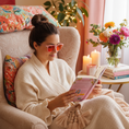 Load image into Gallery viewer, Woman reading book wearing Prettier in Pink nighttime sleep glasses close up