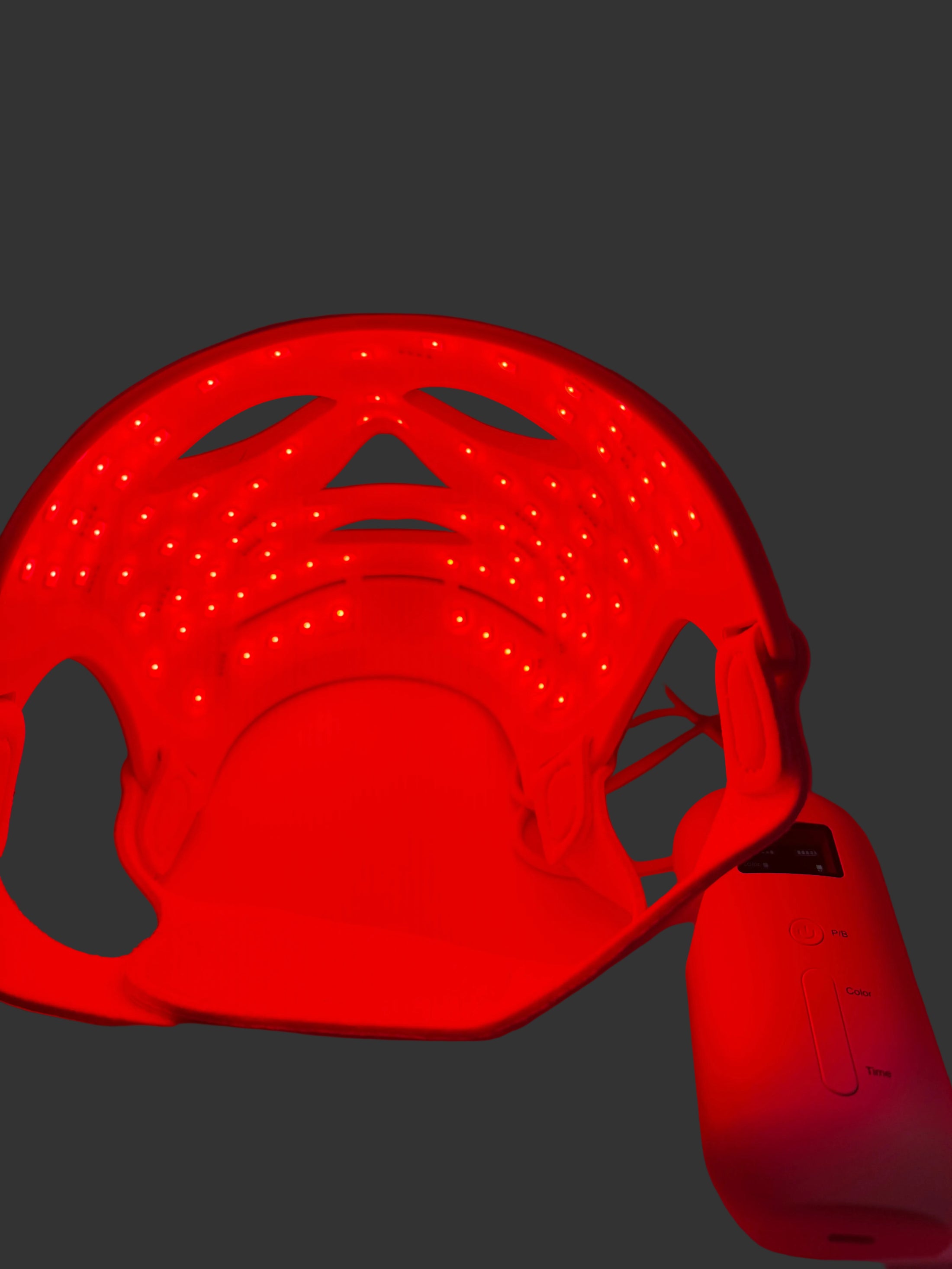 Close-up of a red LED strip light spool on a red background
