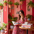 Load image into Gallery viewer, Cat-eye reading glasses in Miami pink coffee shop
