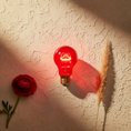 Load image into Gallery viewer, Cherry Bomb red incandescent bulb glowing flat lay with ranunculus and pampas grass

