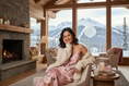 Load image into Gallery viewer, Ski Chalet Romantic LifestyleWoman wearing Rose Quartz Sleep Glasses in cozy ski chalet evening setting

